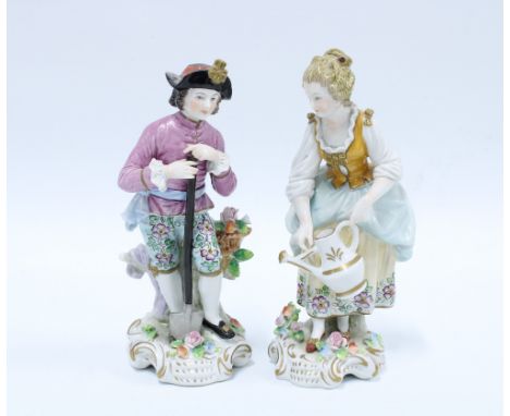 A pair of Sitzendorf porcelain male and female gardening figures, (2) 17cm. 