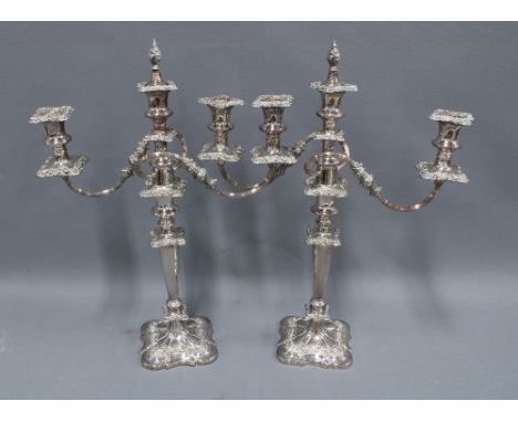 A pair of silver plate on copper candelabra, scrolling arms, flame finial and   knop stemmed, 52cm tall (2) 