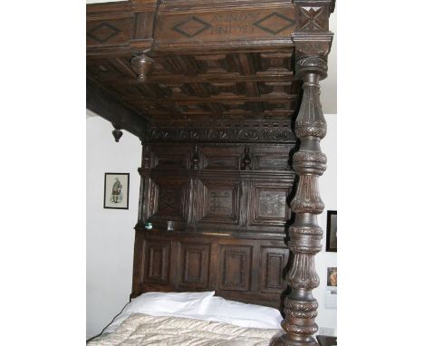 Oak tester bed, triple inlaid panelled back and carved lozenge panelled canopy. 250 x 154 x 220cm. (sold as seen, this item i