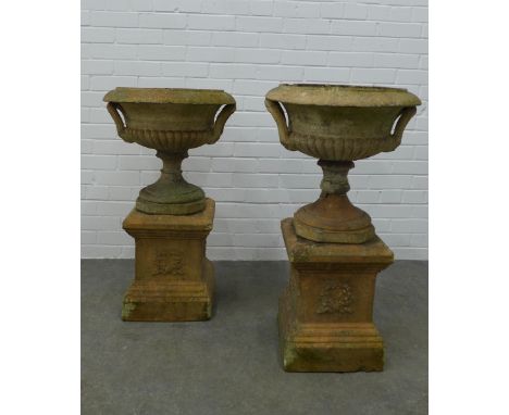 Pair of garden urns, on stands. (one is A/F) 87 x 49cm. (2) 