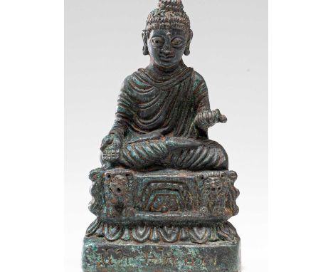 BronzeKashmir , 12th century Dimensions: Height 9 cm Wide 5 cm Depth 3 cmWeight: 96 grams Statue of a seated Buddha on a lotu