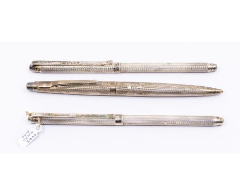A pair of Modern silver cased engine turned ball point pens, hallmarked William Manton, Birmingham, 1990 together with anothe