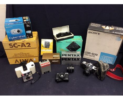A mixed lot of compact disc players, AIWA speaker and a collection of digital cameras, including Nikon.