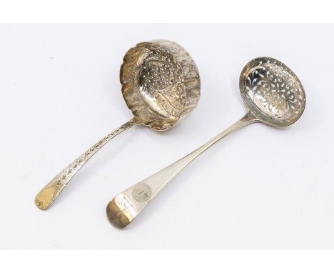Two early 20th Century silver tea strainers, comprising one with repousse berry decoration, Chester 1908 maker mark rubbed, l