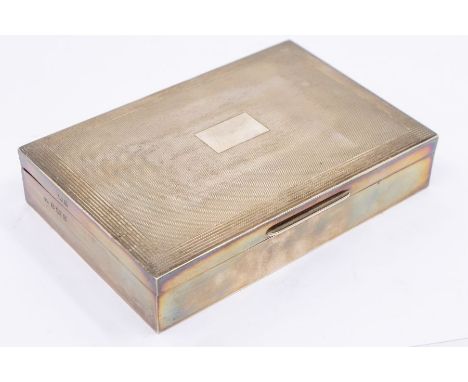 A Modern engine turned silver cigarette case, the cover with reeded borders and central vacant cartouche, fitted interior, li