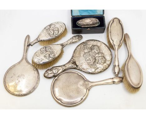 A collection of silver dressing tableware to include; three silver backed mirrors, one with Art Nouveau design and other two 