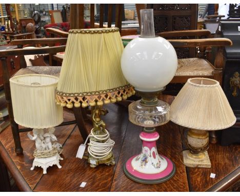 Three mid 20th Century table lamps with early 20th Century oil lamp