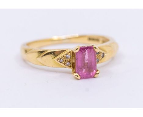 A pink tourmaline and 18ct gold ring, set with a rectangular cut pink tourmaline approx 6x4mm, claw set to textured shoulders