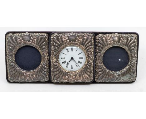 A Modern silver tri compartment framed desk set comprising central desk clock flanked by two photograph frames, on velvet eas