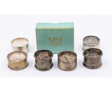 A collection of six 20th Century silver napkin rings, two engine turned, three engraved, one reticulated, various dates and m