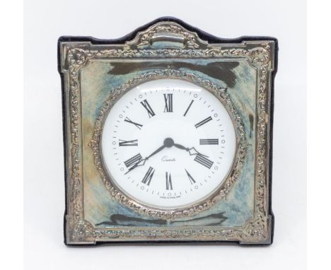 An Edwardian style silver framed desk clock, velvet easel backing, the frame chased with scrolls and foliage banding, surmoun