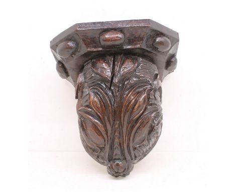 A 17th Century carved oak wall bracket with floral design, probably Continental