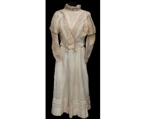 A fine wool and muslin Edwardian wedding dress, 1907, the bodice has a high neck, edged in lace, pin tucked detail, the bodic