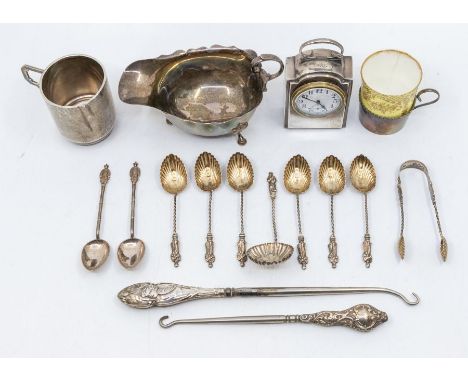 A collection of silver to include; A silver cased Swiss made carriage clock with stylised carrying handle to top and circular