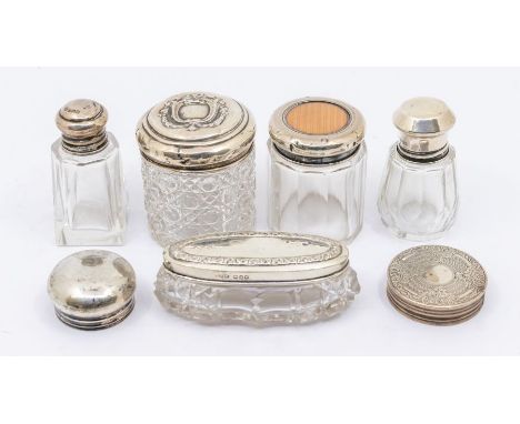 A small collection of silver and glass vanity bottles/containers to include; two silver topped cut glass vanity containers, b