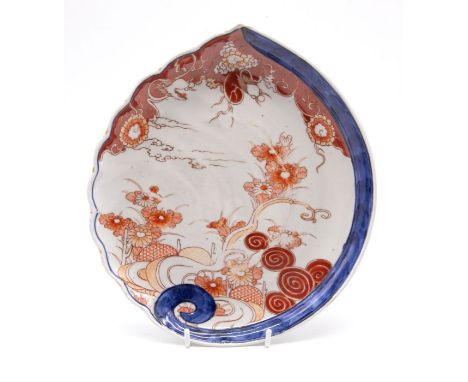 A Chinese Imari scallop shaped serving dish, decorated seascape, trees, flowers, branches and serpents in sky scape, 28cm lon