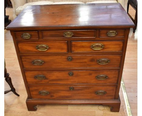 A George III mahogany chest of drawers with three small single drawers, above two drawers, above three and set on bracket fee