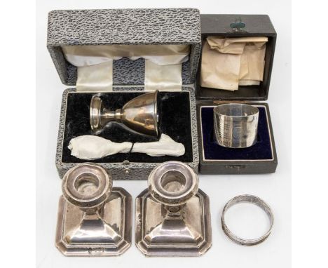 A collection of silver to include: a pair of candlesticks hallmarked for Birmingham 1934 by A.L. Davenport Ltd, a cased silve