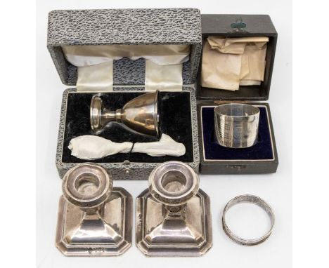 A collection of silver to include: a pair of candlesticks hallmarked for Birmingham 1934 by A.L. Davenport Ltd, a cased silve