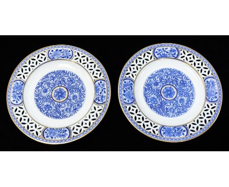 A pair of Minton blue and white reticulated plates, decorated with star flower in central roundel within weaving floral frame