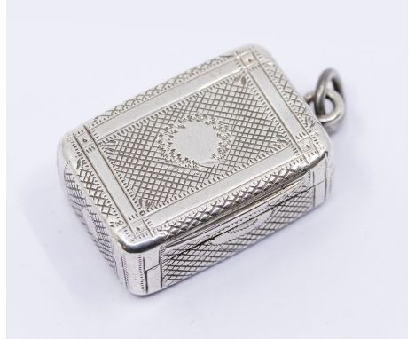 A George III silver vinaigrette with ornate gilt feather foliate grill, engine turned case with central circular cartouche an