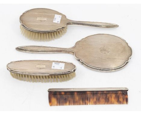 An Elizabeth II modern silver mounted engine turned dressing table set comprising mirror, brush, clothes and comb (4)&nbsp;