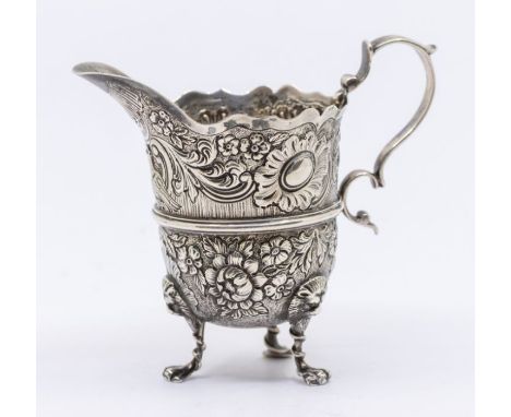 An Edwardian silver large helmet shaped cream jug, the body profusely chased and engraved iwith central bird, flowers, foliag