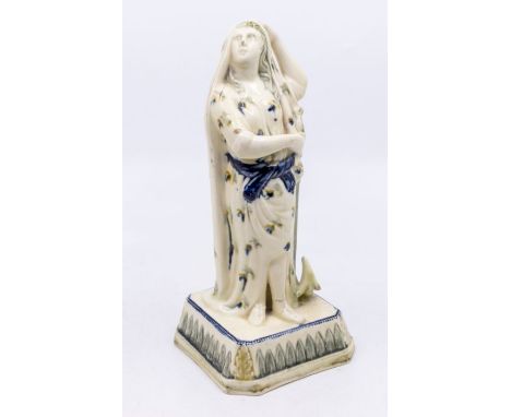 A Prattware figure depicting Hope, standing on a square base with leaf moulding (blue), c.1800. Size: approx. 21cm high.Condi