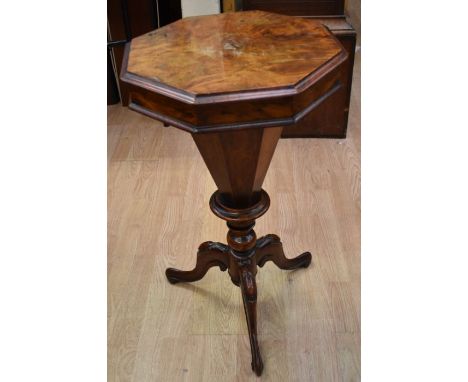 A walnut and mahogany Victorian sewing table on splayed tripod legs, octagonal top