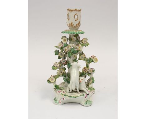 A Derby patch mark figural candlestick, circa 1756-1765, with foliate pierced sconce and floral encrusted stem, the acanthus 