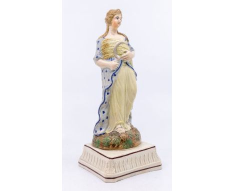 Prattware figure symbolic of Summer, holding a sheaf of corn and a sickle, c.1800. Size: approx. 23cm high.Condition: Good. N
