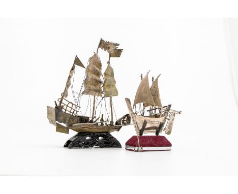 An Asian 925 silver model of a sailing boat, stamped on the rudder, on velvet lined stand together with a gilt metal model of