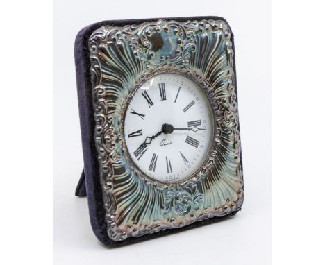 A Modern silver framed desk clock, velvet easel backing, the frame chased with scrolls and foliage, hallmarked by Douglas Pel