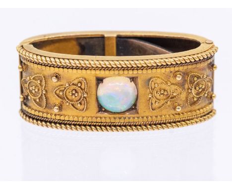 A Victorian 15ct gold and opal scarf clip, comprising a lozenge shaped clip, the centre set with a round cabochon opal, with 