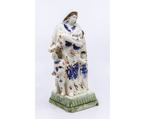 A Prattware figure of Charity, standing on a square base with leaf moulding, c.1800. Size: approx. 23cm highCondition: Child'