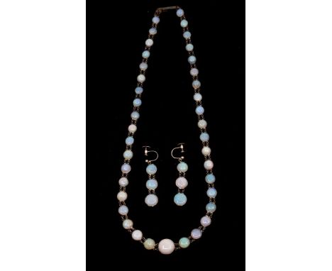 An early 20th century opal and silver necklace, comprising graduated round cabochon opals, optic set in silver, with a lager 