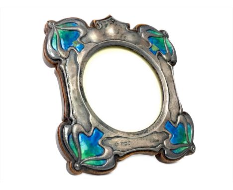 ART NOUVEAU SILVER AND ENAMEL PHOTOGRAPH FRAME, maker William Hutton &amp; Son, London 1904, of shaped square form, with enam