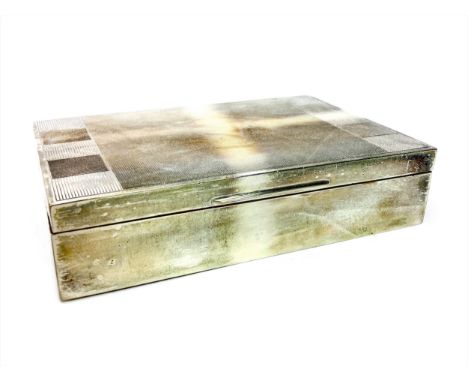 SILVER CIGARETTE BOX, maker Harman Brothers, Birmingham marks, of oblong form, the engine turned hinged cover opening to reve