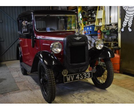 A 1933 Austin 7 box saloon, registration number WV 4333, chassis number B8-8397, engine number 184791, maroon over black. Thi