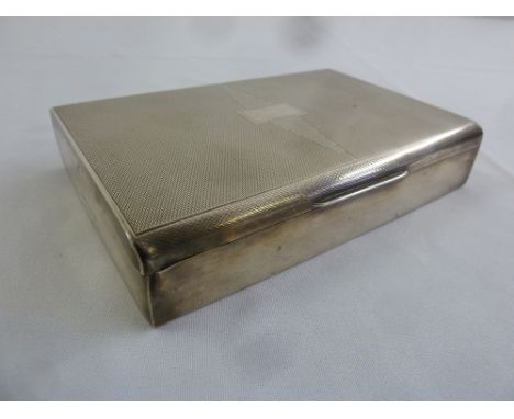 A rectangular silver engine turned cigarette box, Birmingham 1949