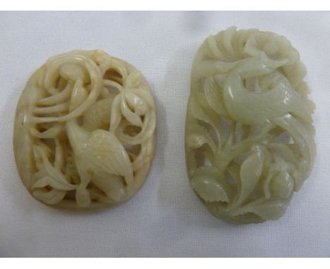 A Chinese jade plaque pieced and carved with birds and vegetation, and a Chinese oval plaque pierced and caved with birds and