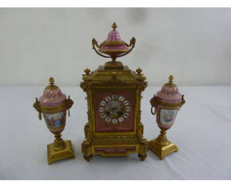 A French 19th century ormolu and porcelain clock set, two train movement with Roman numerals, the vase form garnitures with d