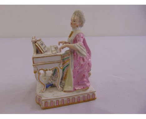 Meissen figurine of a lady playing a piano on raised shaped rectangular base