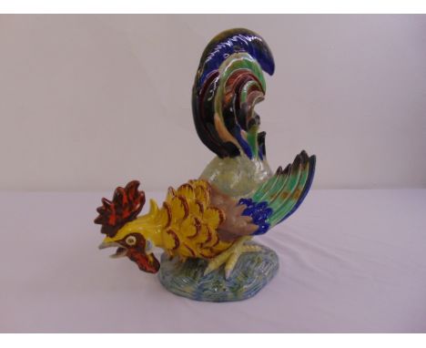 A ceramic figurine of a fighting cock