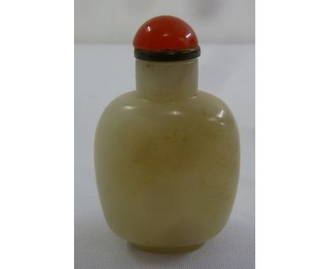A Chinese jade snuff bottle of rounded rectangular form with domed pull off cover