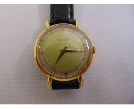 A vintage Jaeger LeCoultre gentlemans wristwatch on black leather strap, tested 18ct gold