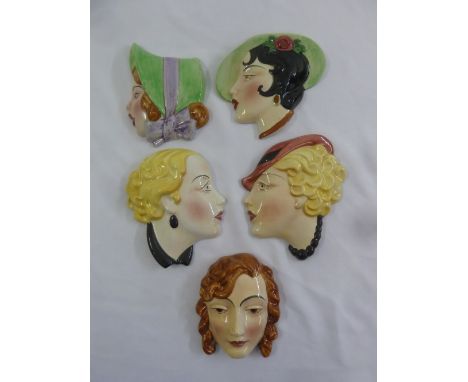Five ceramic wall plaques of Art Deco ladies with various hats and hair styles