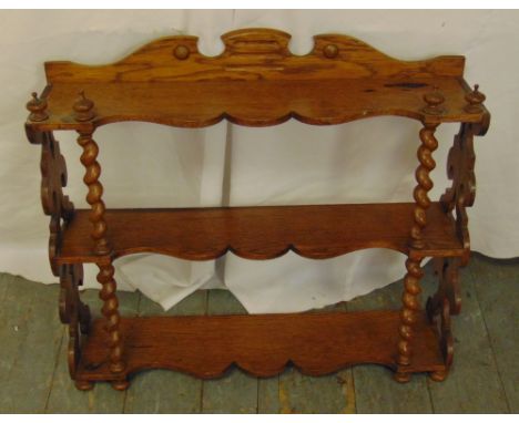 A mahogany three tier wall shelf with barley twist supports