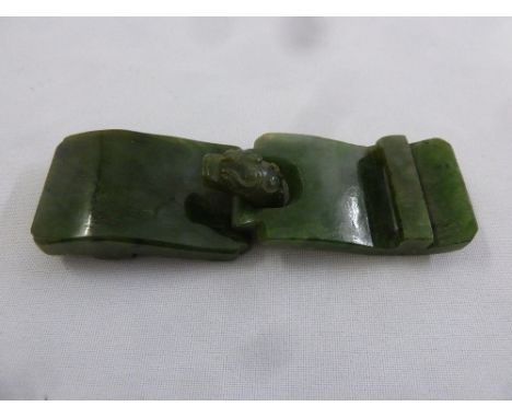 A Chinese green polished jade two part belt buckle with dragon head clasp