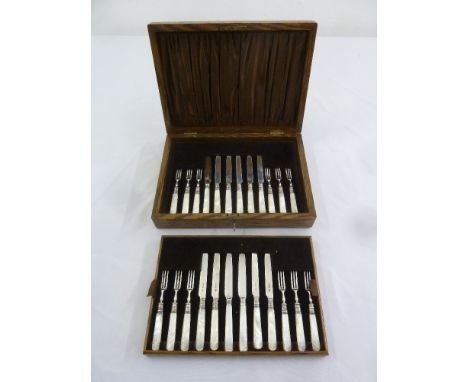 A cased set of dessert eaters with silver blades and Mother of Pearl handles for twelve place settings